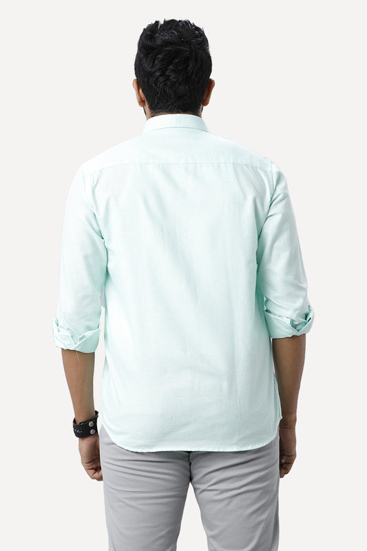 Back View light blue shirt and gray pants