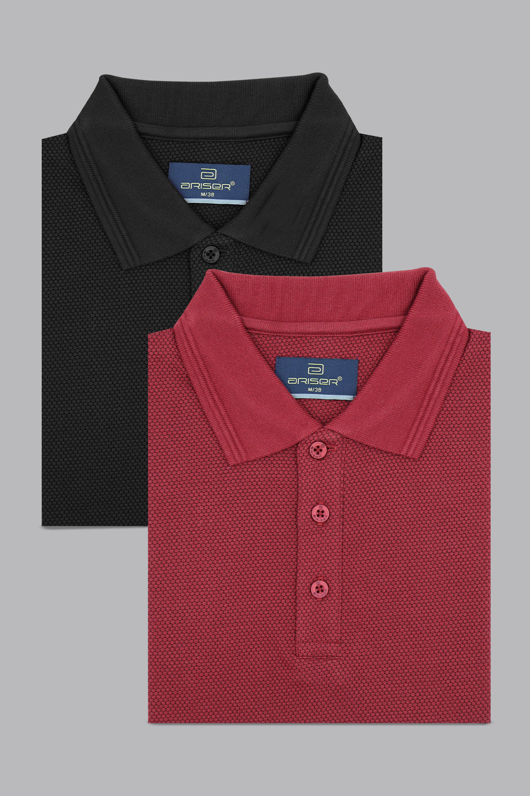 Two folded polo shirts, one black and one red, with a brand label on a gray background.