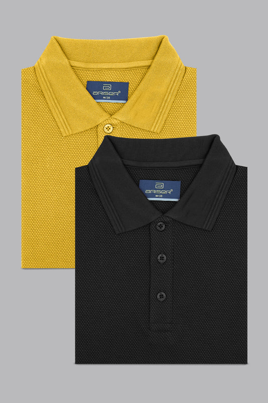 Two folded polo shirts, one yellow and one black, on a gray background.