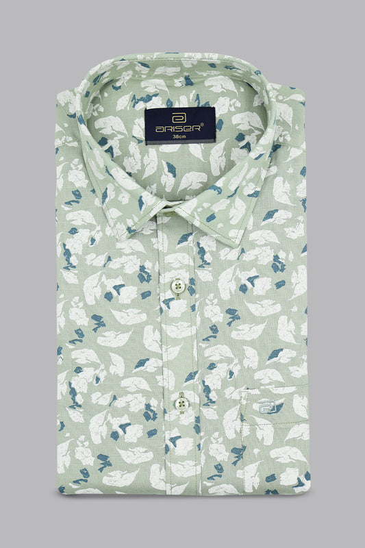 Green shirt with white floral pattern on a gray background