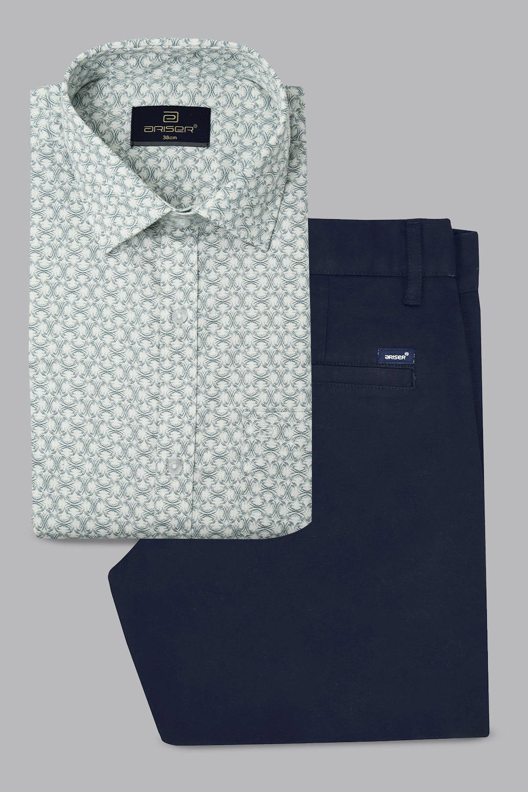 Green patterned shirt and navy pants on a gray background
