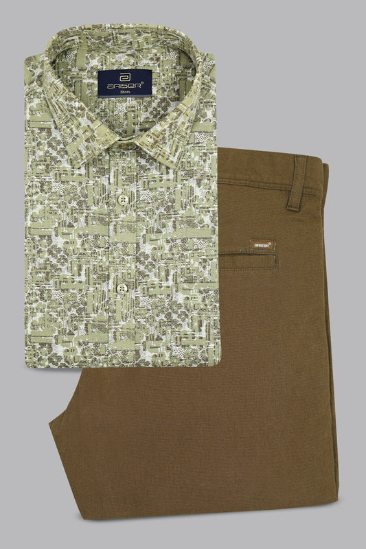 Green patterned shirt and brown pants on a gray background