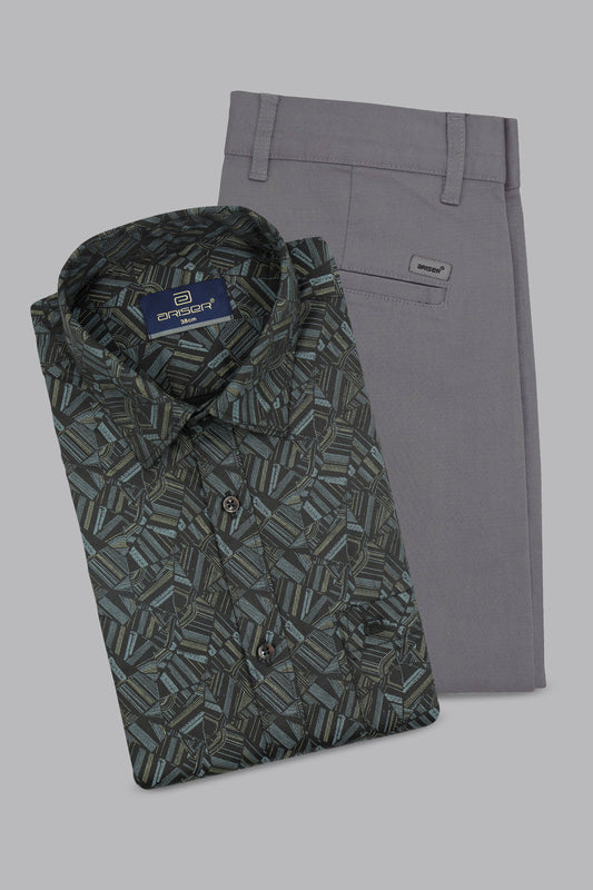 Folded patterned shirt and gray pants on a light gray background