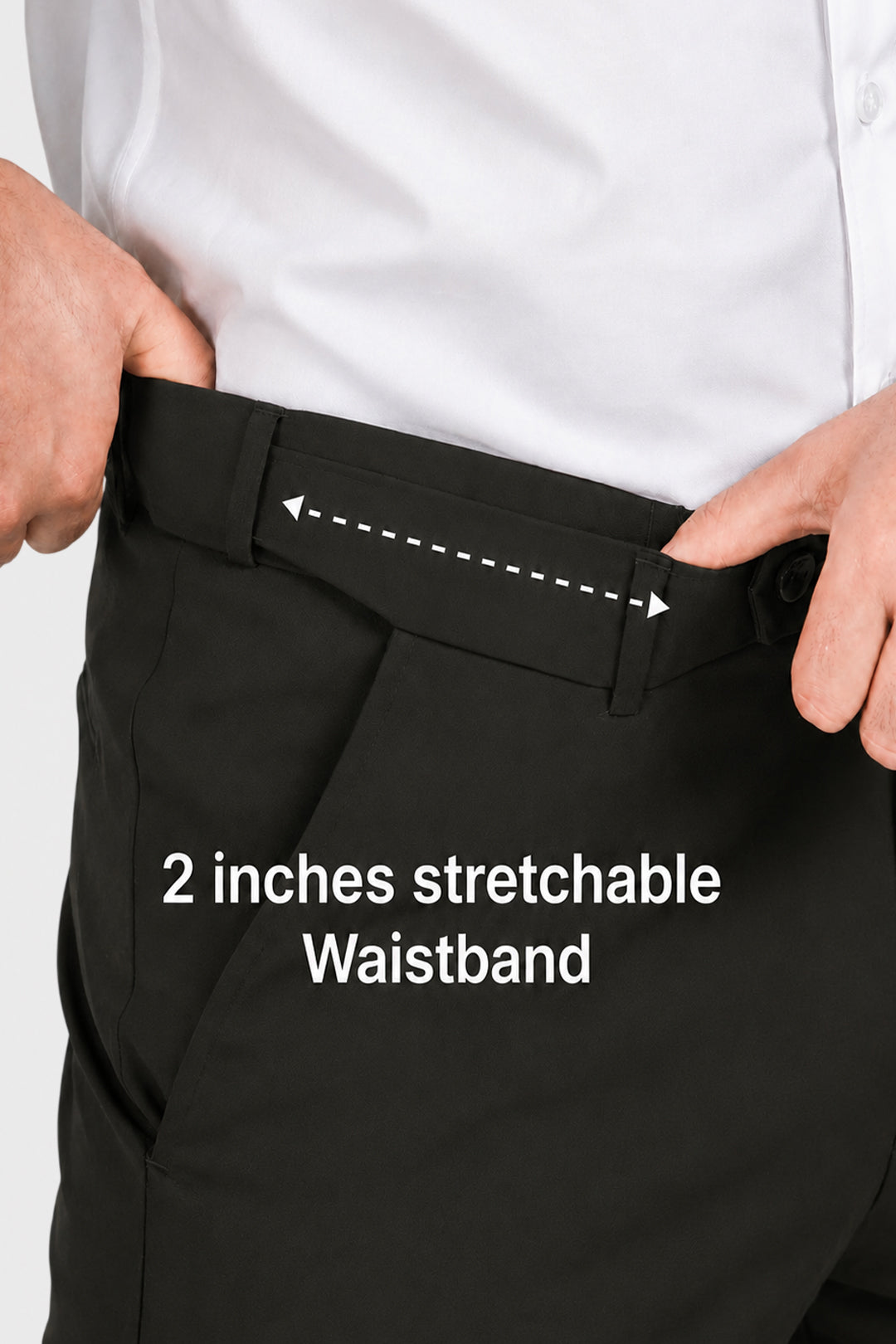 Close-up of a person wearing black trousers and a white shirt, demonstrating a stretchable waistband with hands pulling the front panel outward. White text reads '2 inches stretchable Waistband' with a dashed arrow indicating the stretch area.