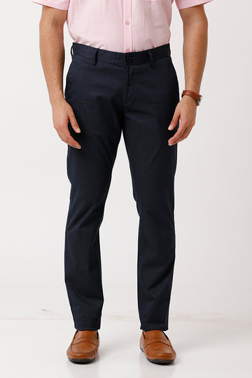 A man wearing dark navy blue slim-fit trousers.