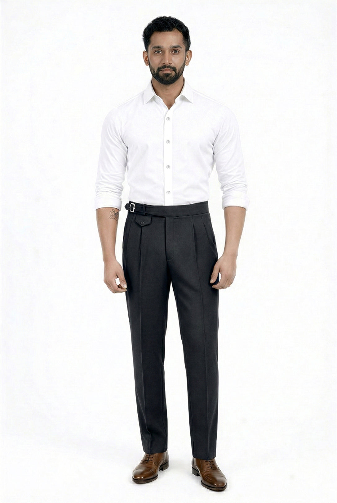 Man wearing a white shirt and dark trousers on a white background