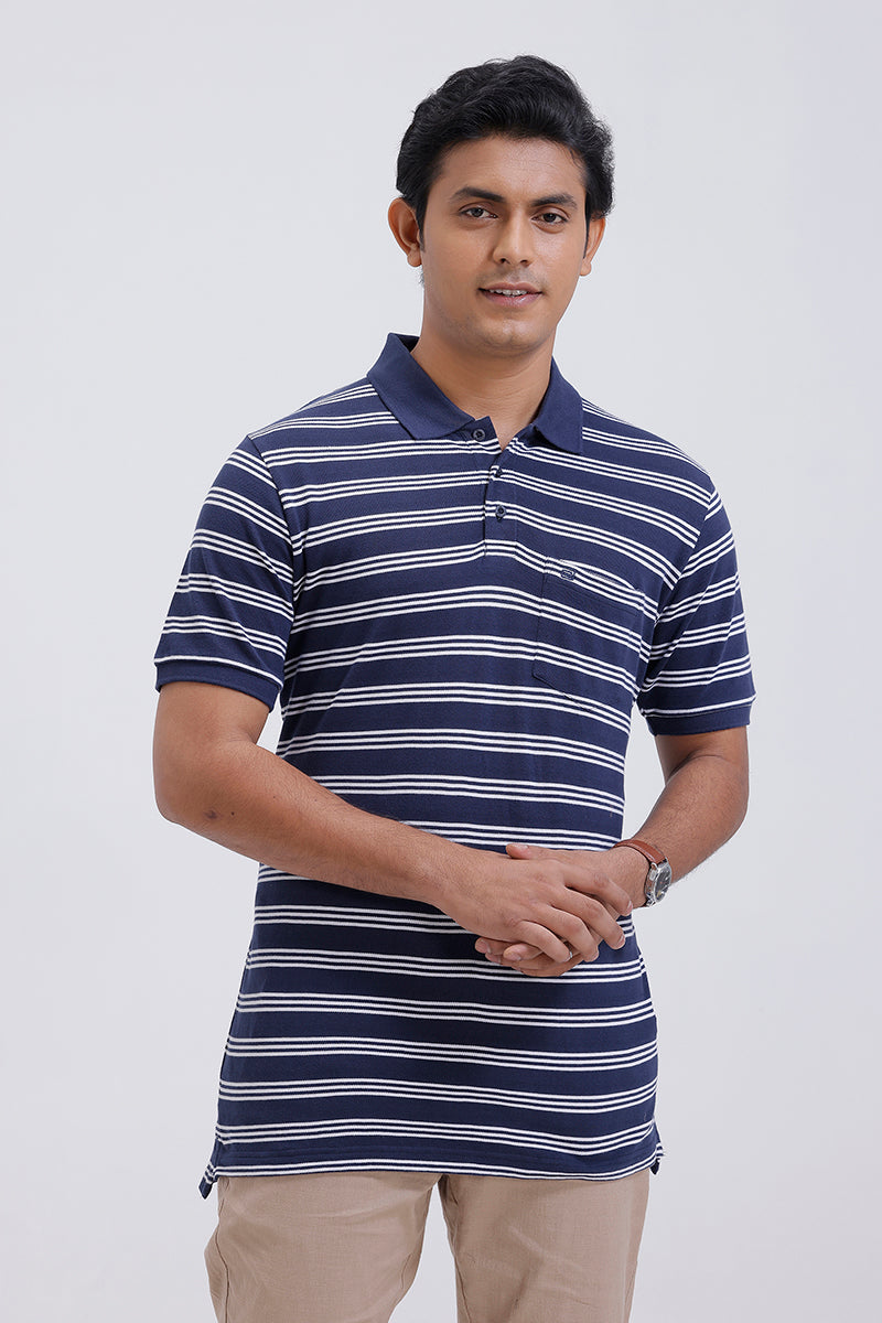 Man wearing a navy and white striped polo shirt on a light gray background