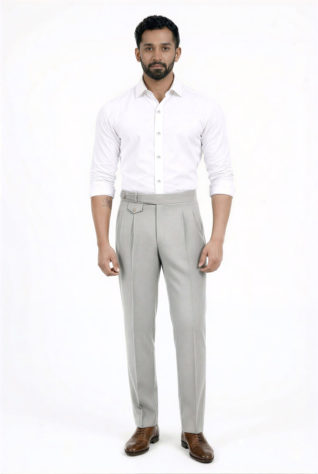 Man wearing a white shirt and gray pants on a white background