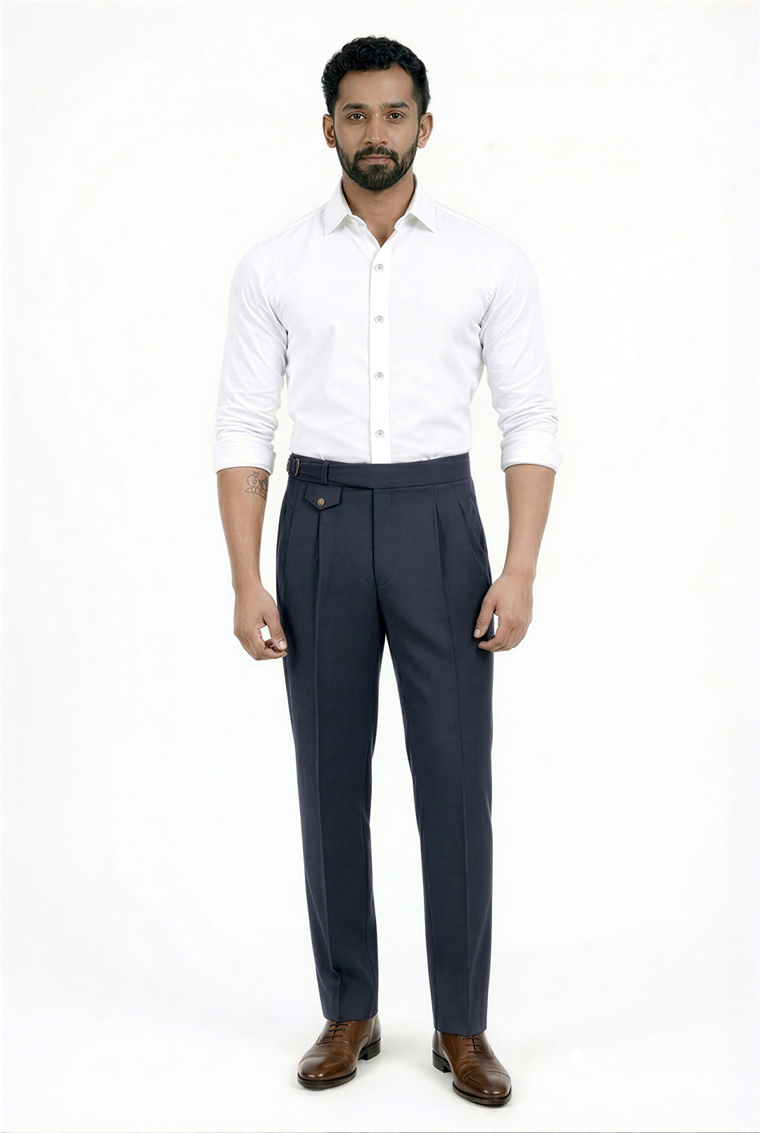 Man wearing a white shirt and navy blue trousers on a white background