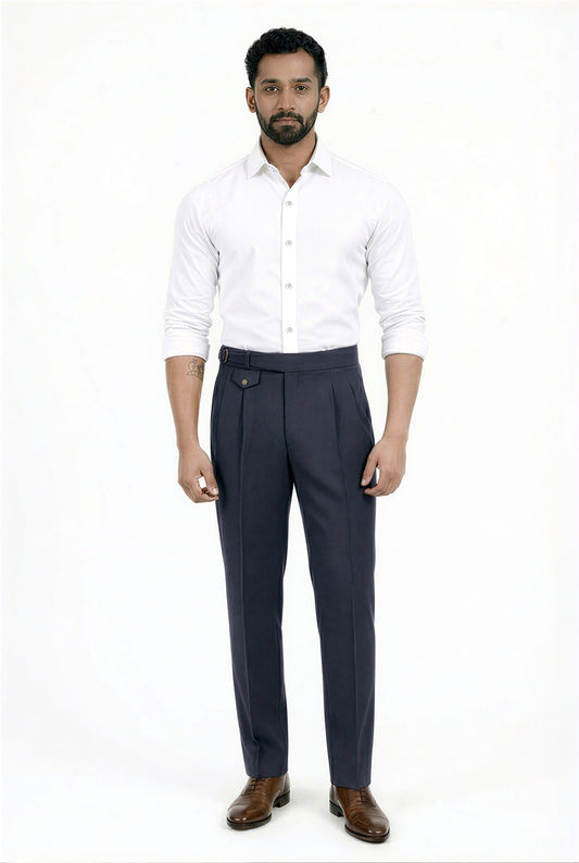 Man wearing a white shirt and navy blue trousers on a white background