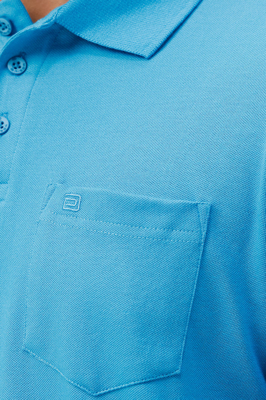 Close-up of a blue polo shirt with a pocket.