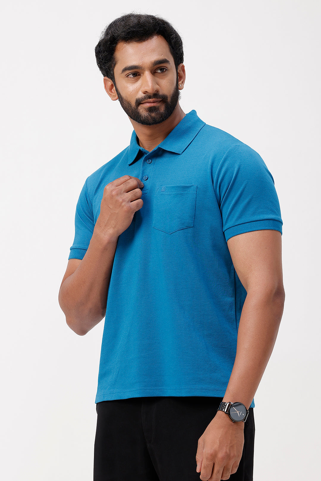 Man wearing a royal blue polo shirt on a white background