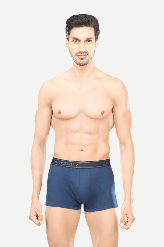 Man wearing a blue boxer brief with a visible brand logo on a white background